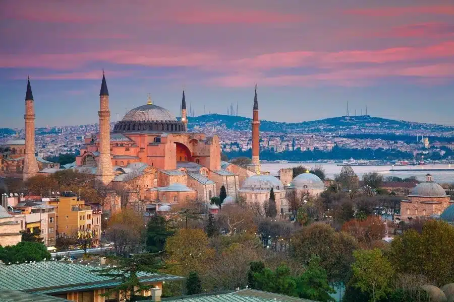 Exterior of Hagia Sophia with its massive domes and minarets, blending Byzantine and Islamic architectural styles.