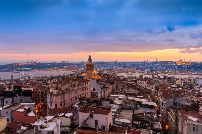 a city with a tower and water in the background