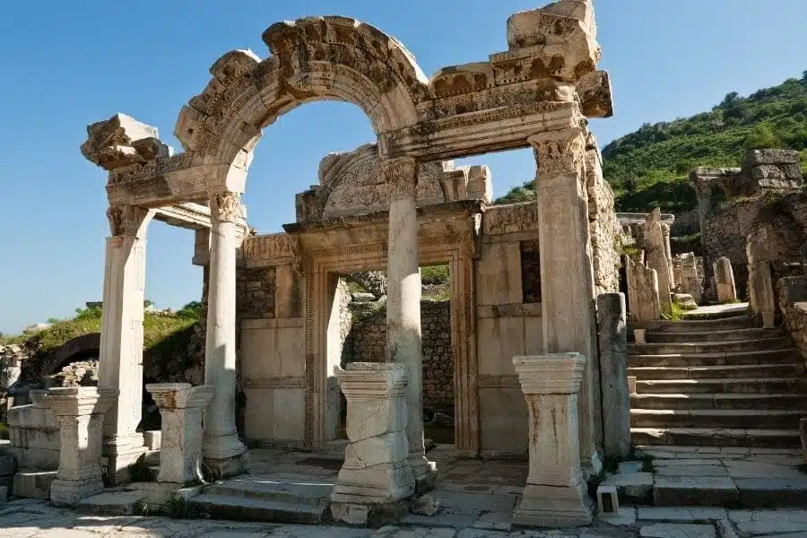 Ruins of the Temple of Hadrian in Ephesus, featuring ornate stone carvings and classical columns.